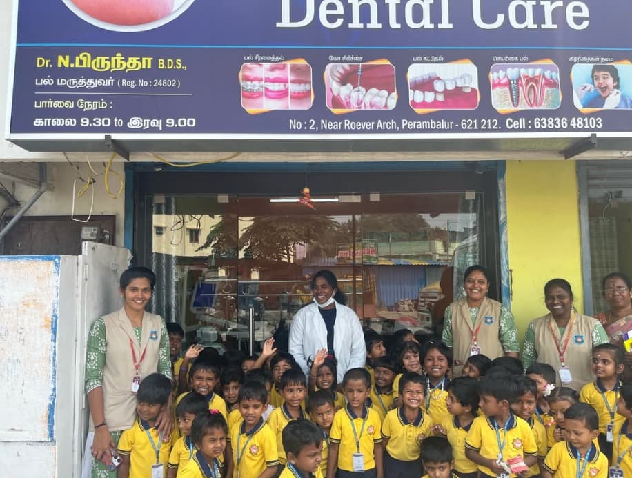Dr. N. Biruntha and the Clear Dental Care team outside the clinic in Perambalur with children from a school dental camp